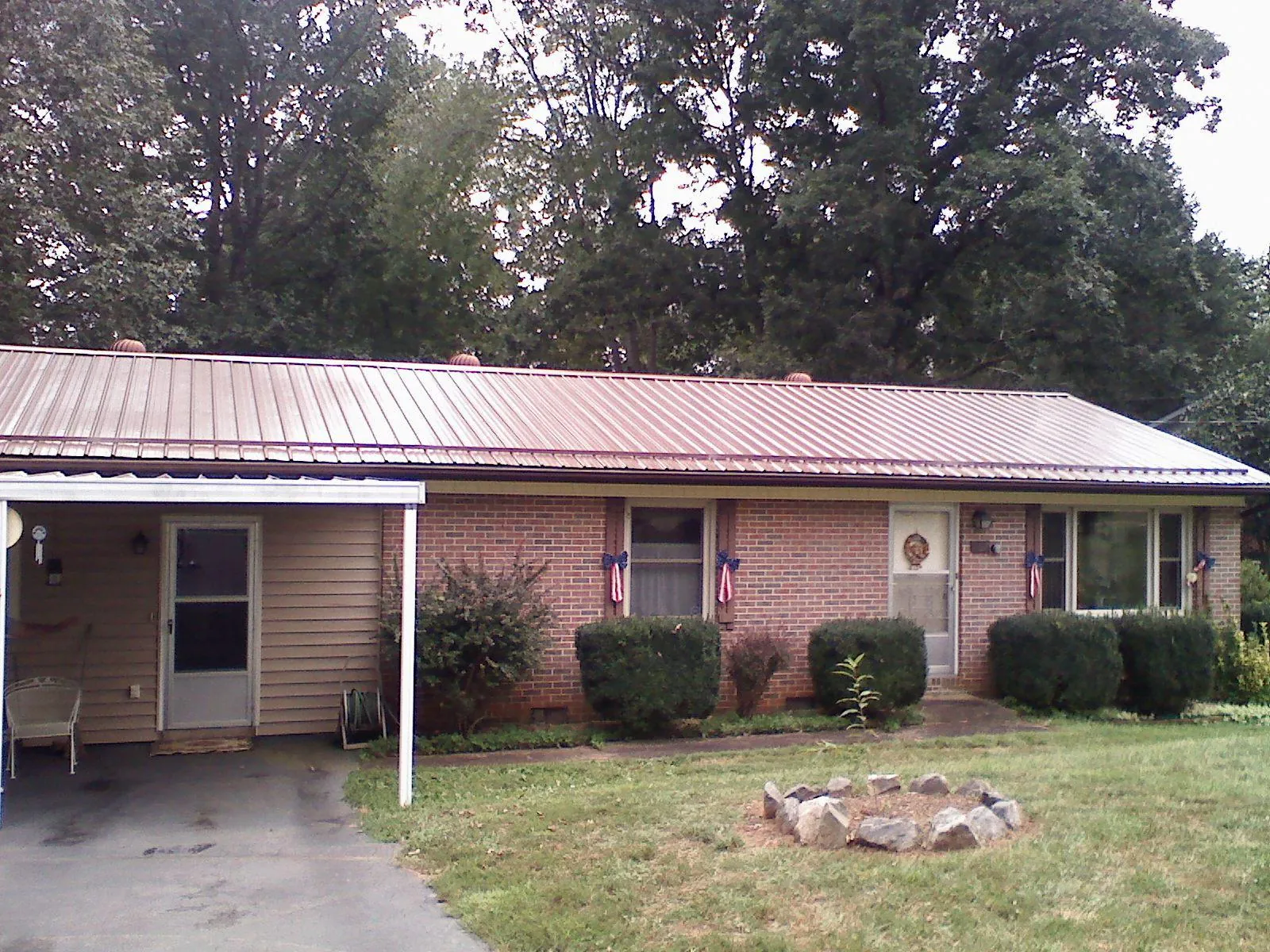 Bronze metal roof and carport on a brick ranch home — Roof Repair work by our crew in Ocean Beach
